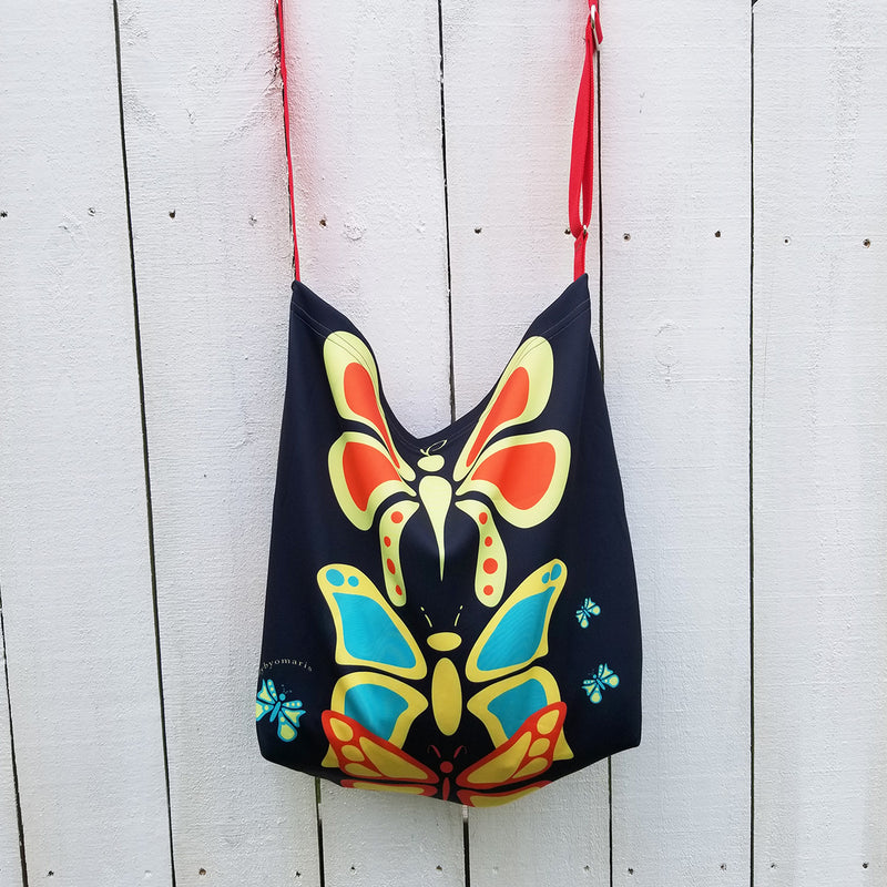 Butterflylove Tote is the perfect size for carrying a change of clothes, your Butterfly Makeup Bag, and why not? Your favorite book! . Tote made from a soft, supple double knit neoprene fabric, 92% polyester, 8% spandex. Butterfly vibrant design. Easy adjustable 44" strap. by RedButterfly by Omaris
