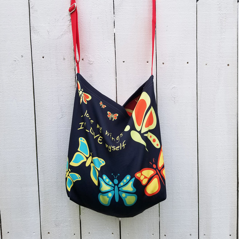 Butterflylove Tote is the perfect size for carrying a change of clothes, your Butterfly Makeup Bag, and why not? Your favorite book! . Tote made from a soft, supple double knit neoprene fabric, 92% polyester, 8% spandex. Butterfly vibrant design. Easy adjustable 44" strap. by RedButterfly by Omaris