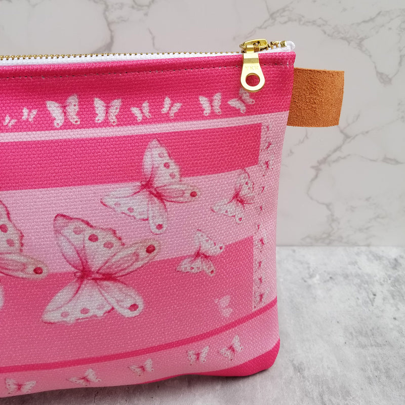 From art supplies to keepsakes, baby necessities, travel gear, or gadget cases, this Goddess Pink Pouch is amazing!  Vibrant print, durable canvas shell, and denim lining. Beautiful watercolor pink butterflies. - Denim Lined - 100% polyester textured canvas - Metal zipper - Size 10 inches