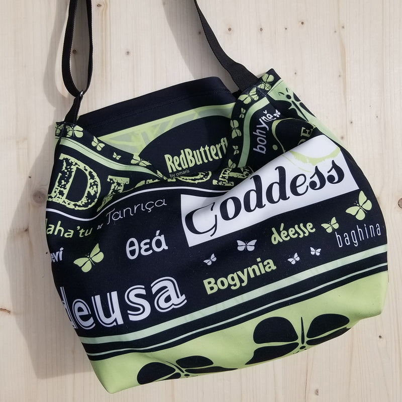 This Goddess Mint Tote is for you! - Tote made from soft neoprene fabric, 92% polyester, 5 spandex. - Goddess word translated in some languages. - Easy adjustable 44" strap - Strong metal hardware and professional bar tacking - Monochromatic watercolor butterflies on fabric - Exclusive design by RedButterfly by Omaris 