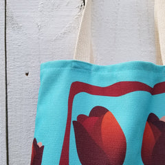 With room for notebooks and a laptop, Reblossom Tote can be so versatile!  A beautiful combination of blue color, stripes, and tulips. - 100% polyester textured canvas withstands everyday use while looking great - Unique design that will never fade. - Cotton webbed 1