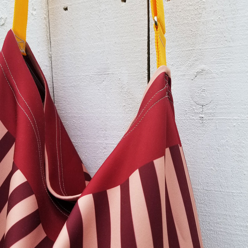 Earthy and neutral colors, perfect to match with any clothing you may have. The Reblossom Brown Tote is what you need to complete your wardrobe. Beautiful print inside for inspiration. A beautiful combination of stripes and tulips. - Made with soft neoprene fabric, 92% polyester, 8% spandex - With an easy 44" adjustable strap for comfort - Strong metal hardware and professional bar tacking - Exclusive design by RedButterfly by Omaris  