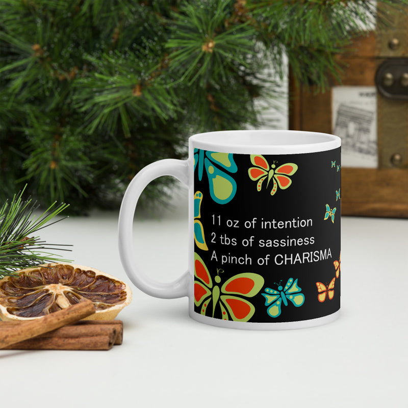 Whether you're drinking your morning coffee, your evening tea, or something in between – this mug is for you! I prefer to drink "Café con Leche" with my Butterfly Charisma Mug every morning. - Ceramic - Dishwasher and microwave safe - White and glossy by RedButterfly by Omaris